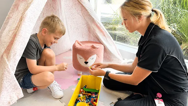 ORS-Positive-Behaviour-Support-Practitioner-working-with-a-child-through-play-based-therapy-to-build-skills-confidence-and-independence-for-children-adults-and-families