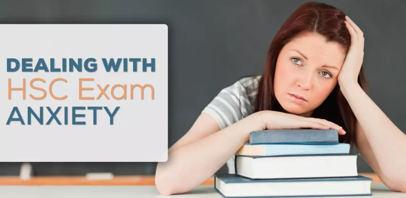 Young person dealing with anxiety with hand on stack on books