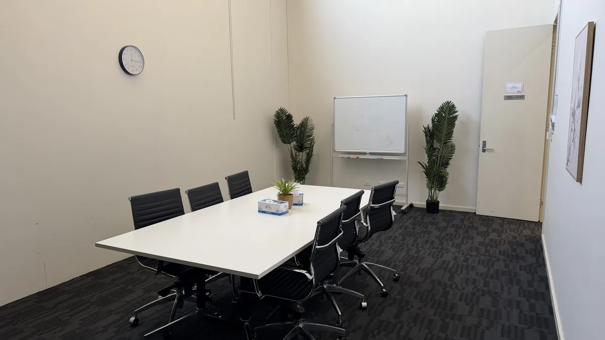 Assessment and training room with a large meeting table, office chairs and whiteboard at ORS Coburg