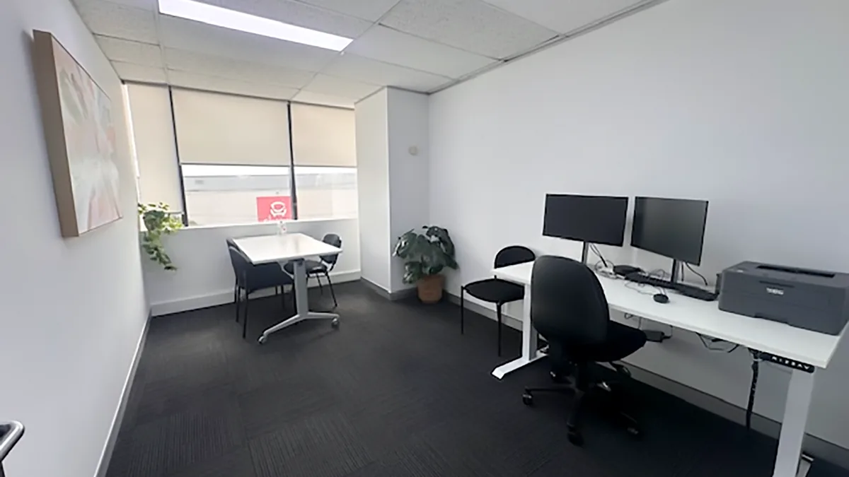 Consulting room with a clinician workstation, meeting table and window at ORS Fairfield East