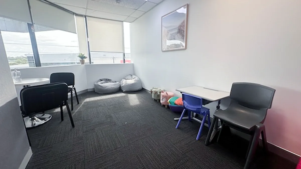 Paediatric appointment room with beanbags, a children's desk and chairs by the window at ORS Fairfield East