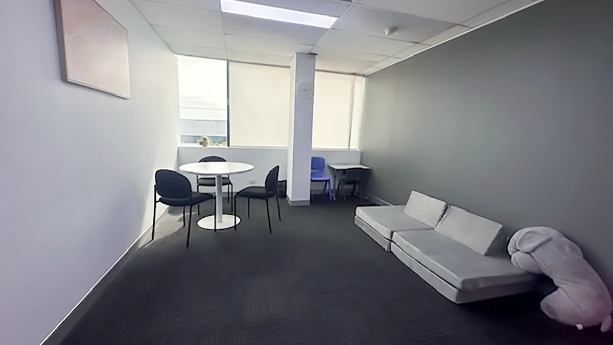 Paediatric therapy room with soft play cushions, a round table and child-sized furniture at ORS Fairfield East