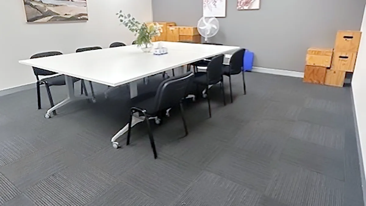 Training and assessment room with a long meeting table, office chairs and artwork at ORS Fairfield East