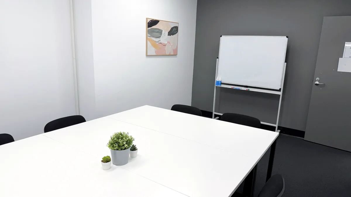 Training and assessment room with a white meeting table, chairs and a whiteboard at ORS Fyshwick