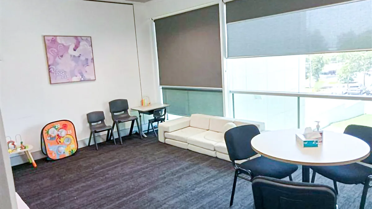Paediatric appointment room with a soft play lounge, kids' chairs, a round table and window at ORS Jandakot