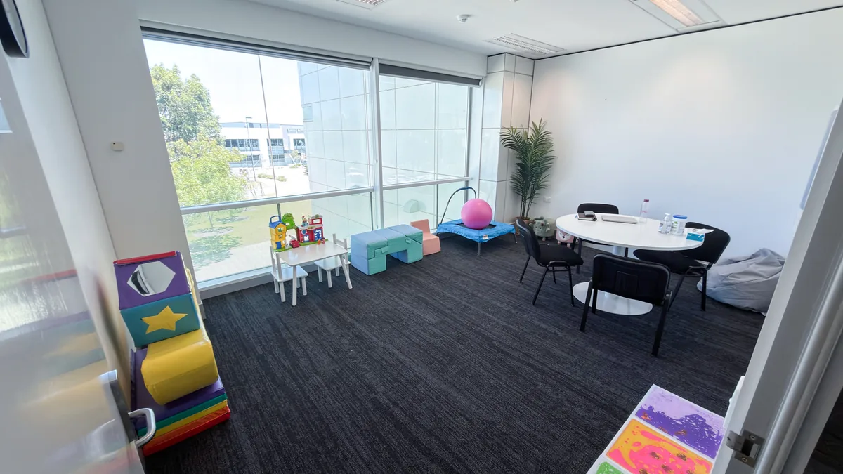 Paediatric therapy room with a play corner, soft blocks, a round table and a large window at ORS Jandakot