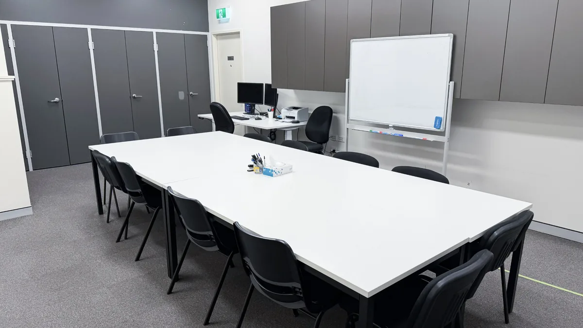 Assessment and training room with a large meeting table, chairs and whiteboard at ORS Mandurah