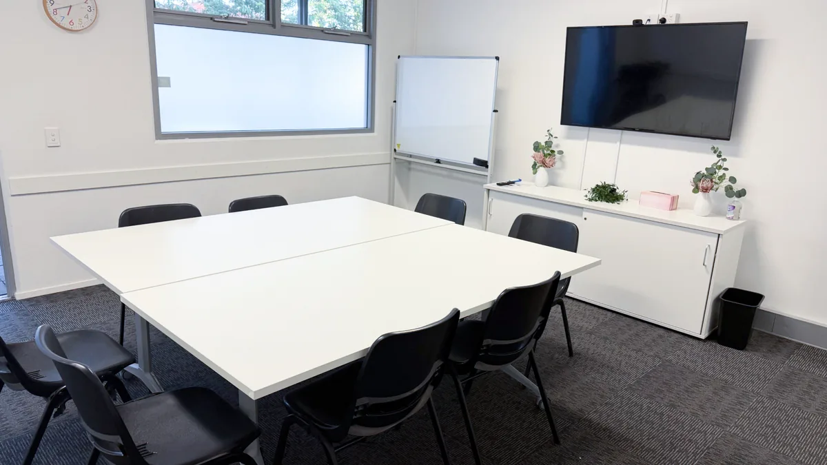 Training and assessment room with a meeting table, chairs, whiteboard and wall-mounted screen at ORS Morley