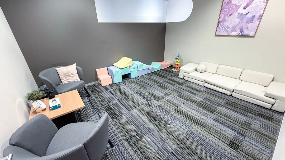 Counselling and paediatric room with a soft play lounge, colourful play blocks and armchairs at ORS Stirling