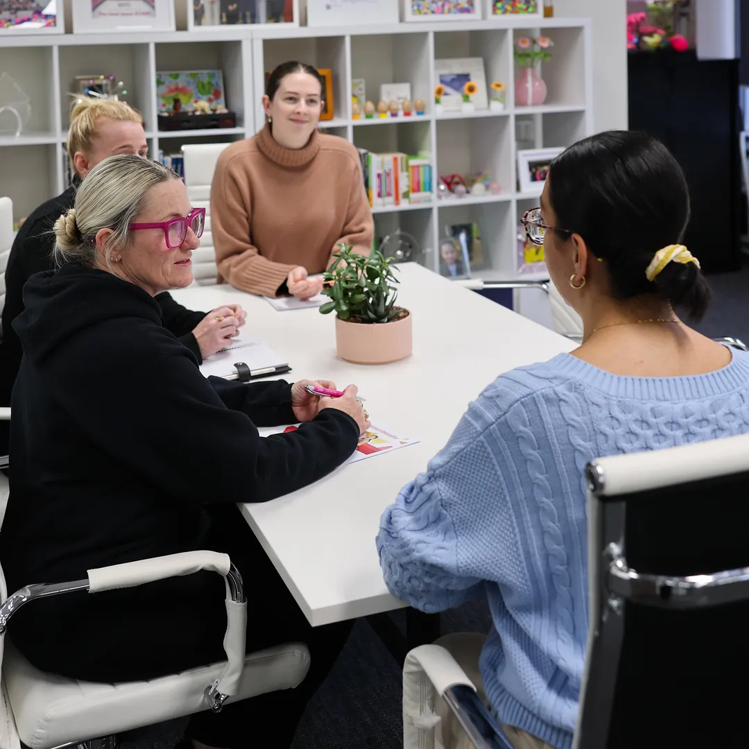 Positive Behaviour Support practitioners meeting with carers as part of trauma-informed behaviour support for children in out-of-home care.