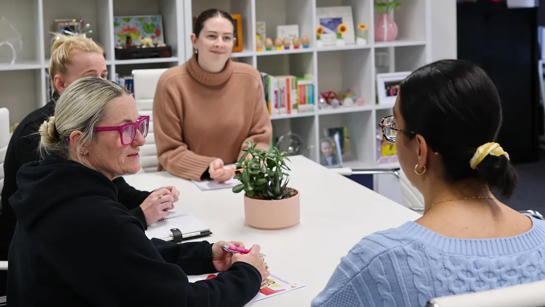 Positive Behaviour Support practitioners meeting with carers as part of trauma-informed behaviour support for children in out-of-home care.